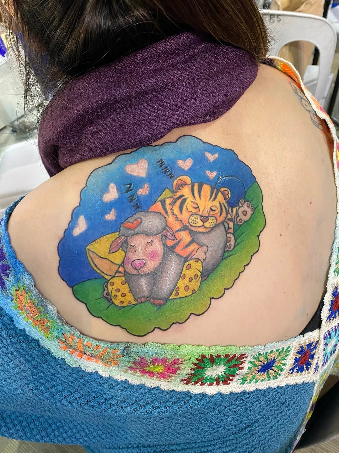 Tiger and sheep sleeping tattoo on the back by Ferds Villanueva