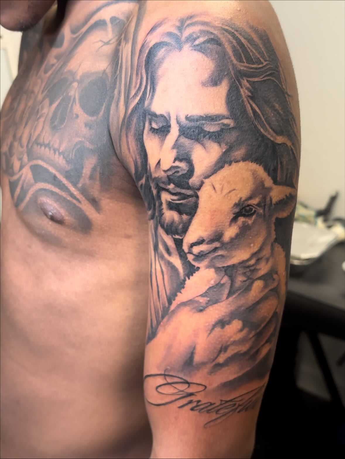 Jesus holding lamb realism tattoo on the upper arm by FleeDott 🇨🇴