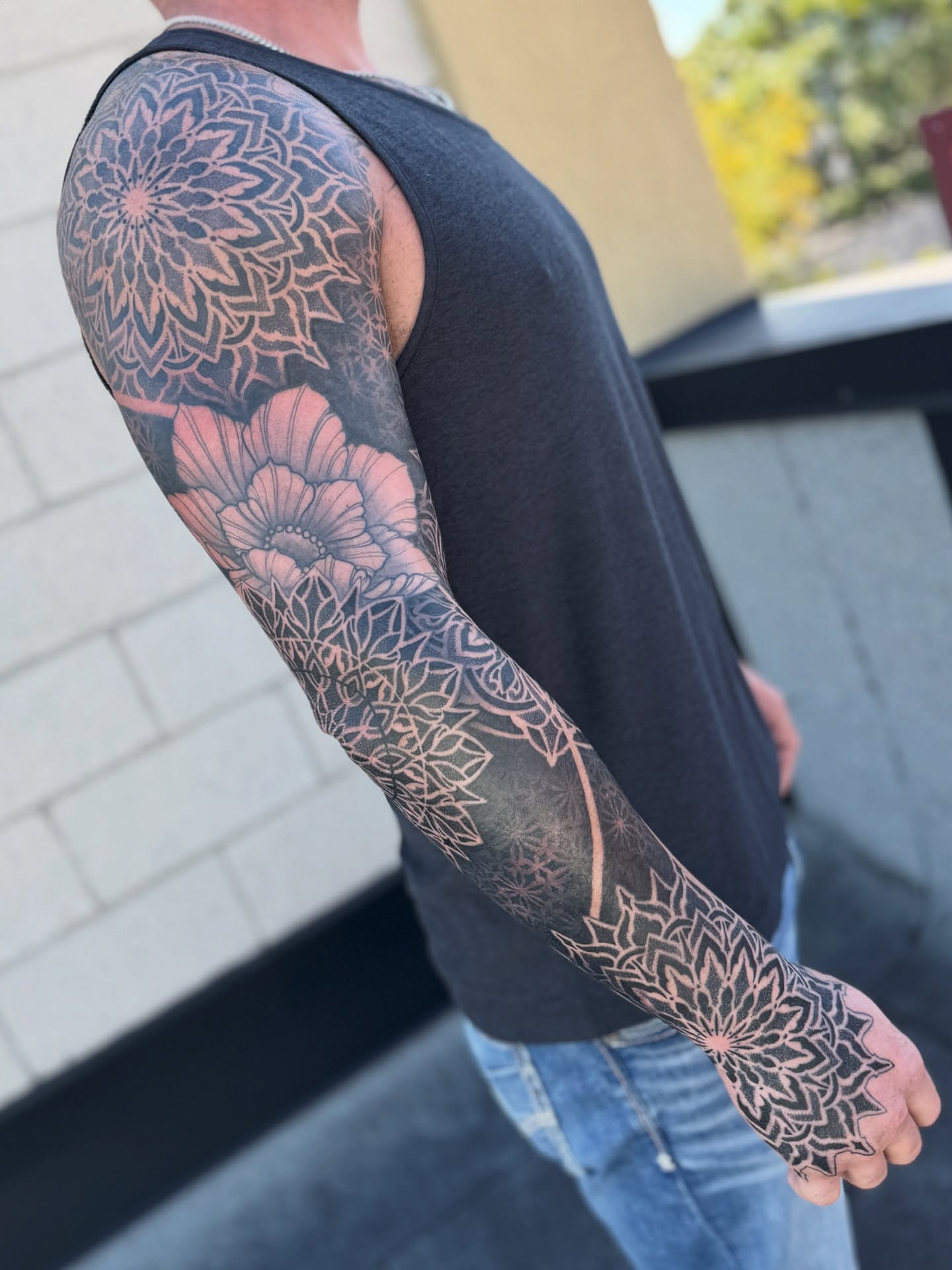 Floral mandala geometric tattoo on the upper arm by Laure Conzales