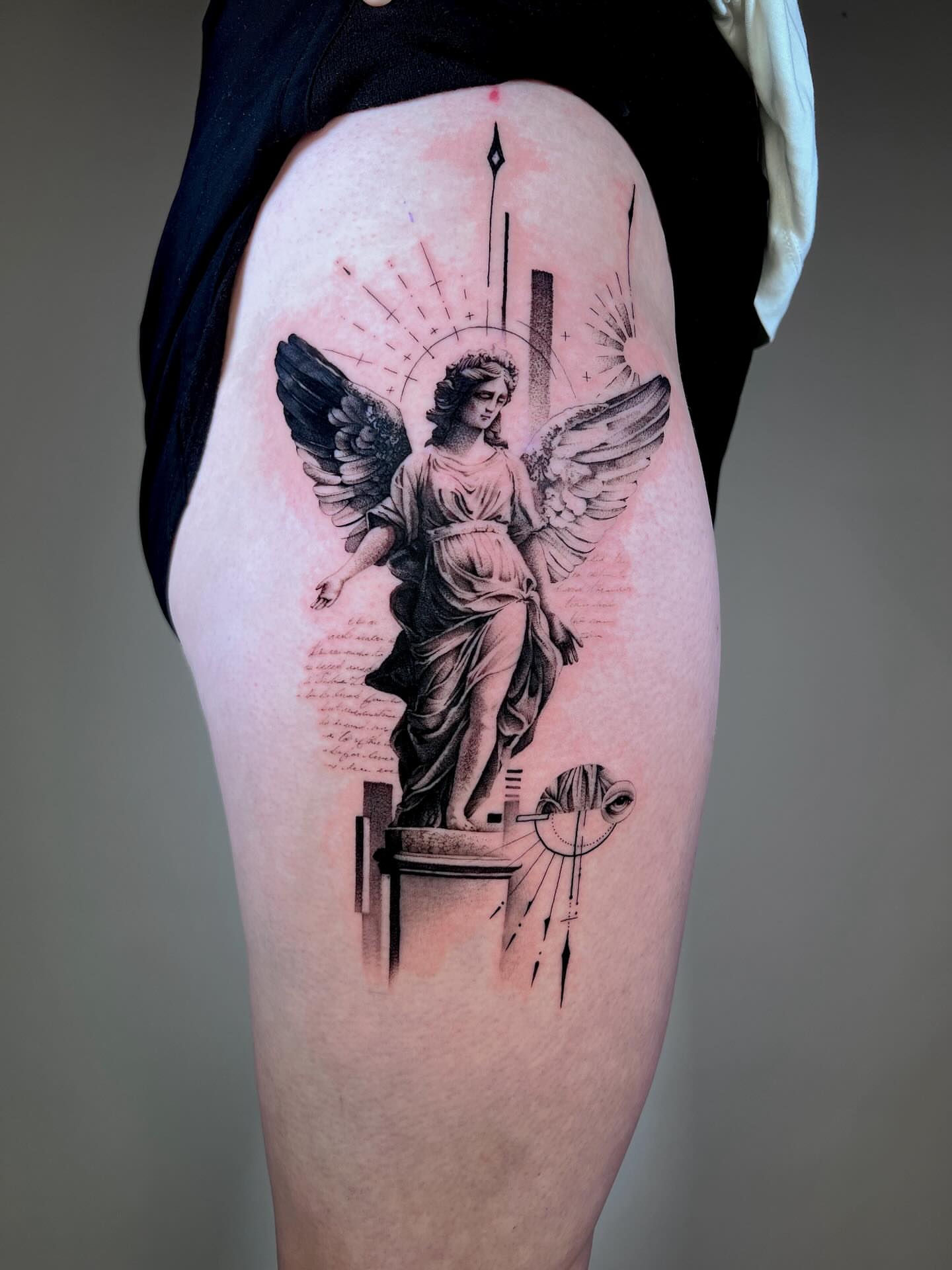 Statue of an angel realism tattoo on the thigh by Dolph.