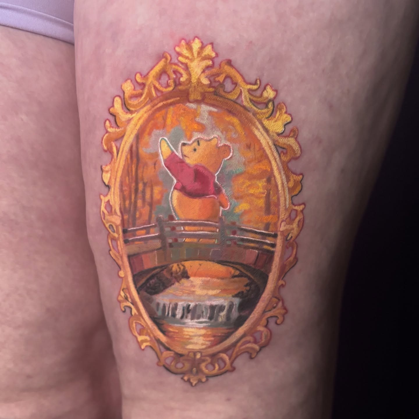 Winnie the Pooh illustrative tattoo on the thigh by Rayvin Patton