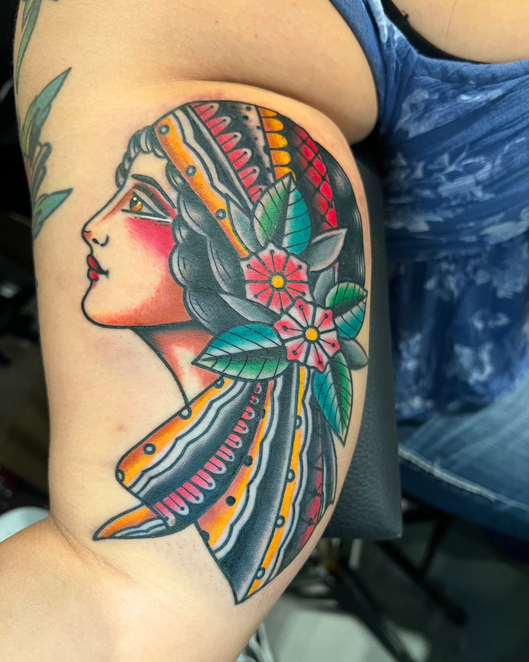 Woman with headdress American traditional tattoo on the shoulder by Massimiliano pennella