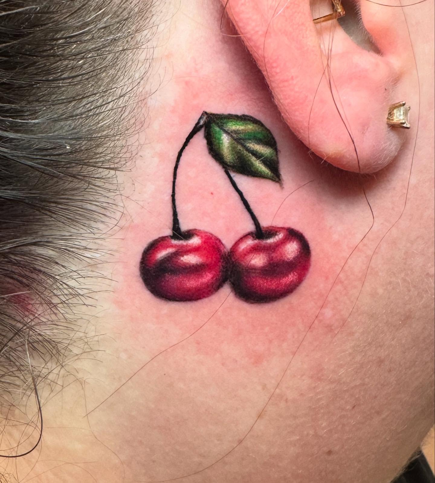 Cherries realism tattoo on the neck by Brian Herrera