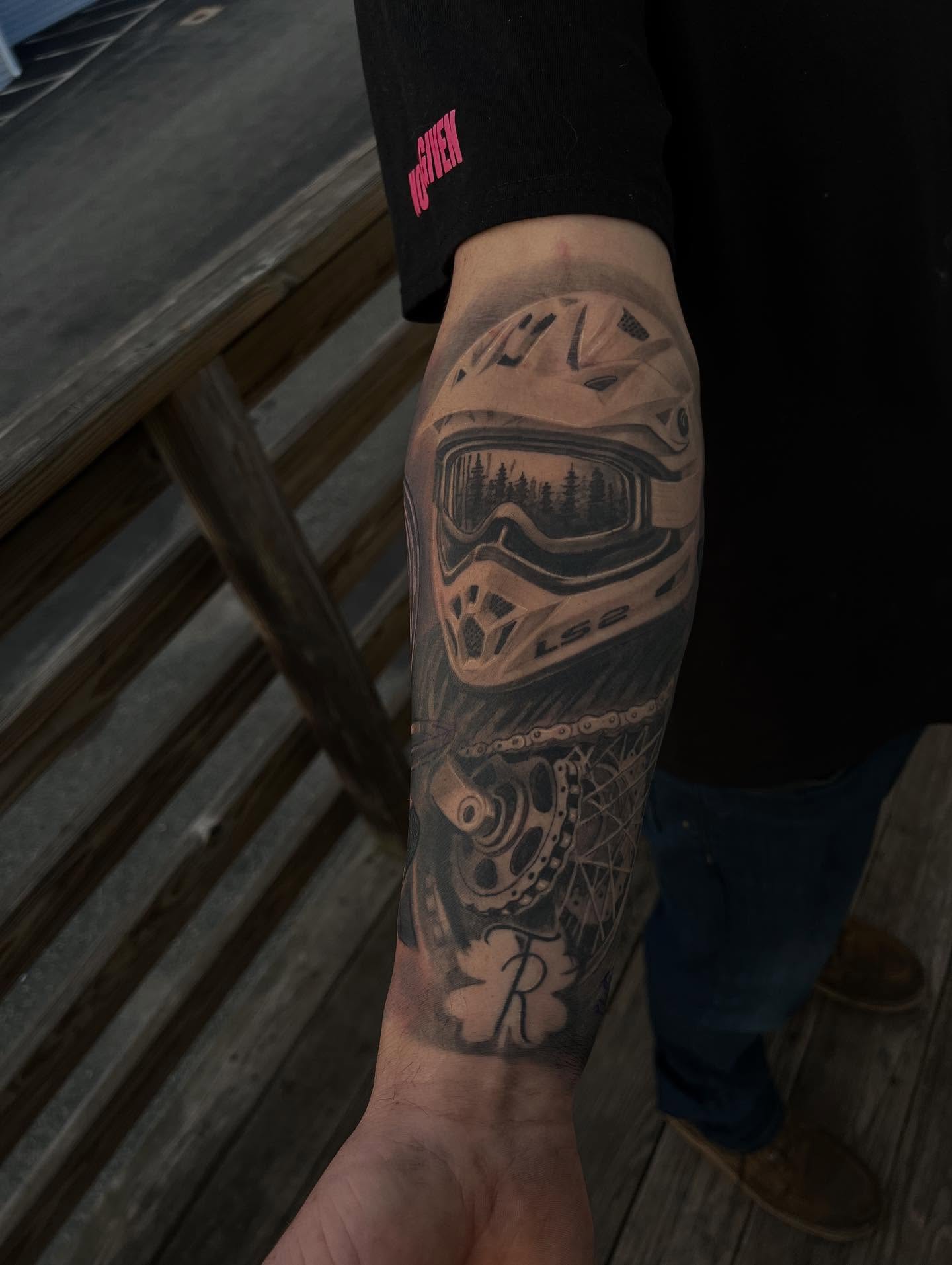 Ski helmet realism tattoo on the forearm by Mark Phillip Chavez