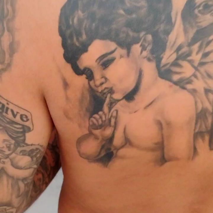 Cherub with finger to lips realism tattoo on the chest by Alfredo Sosa