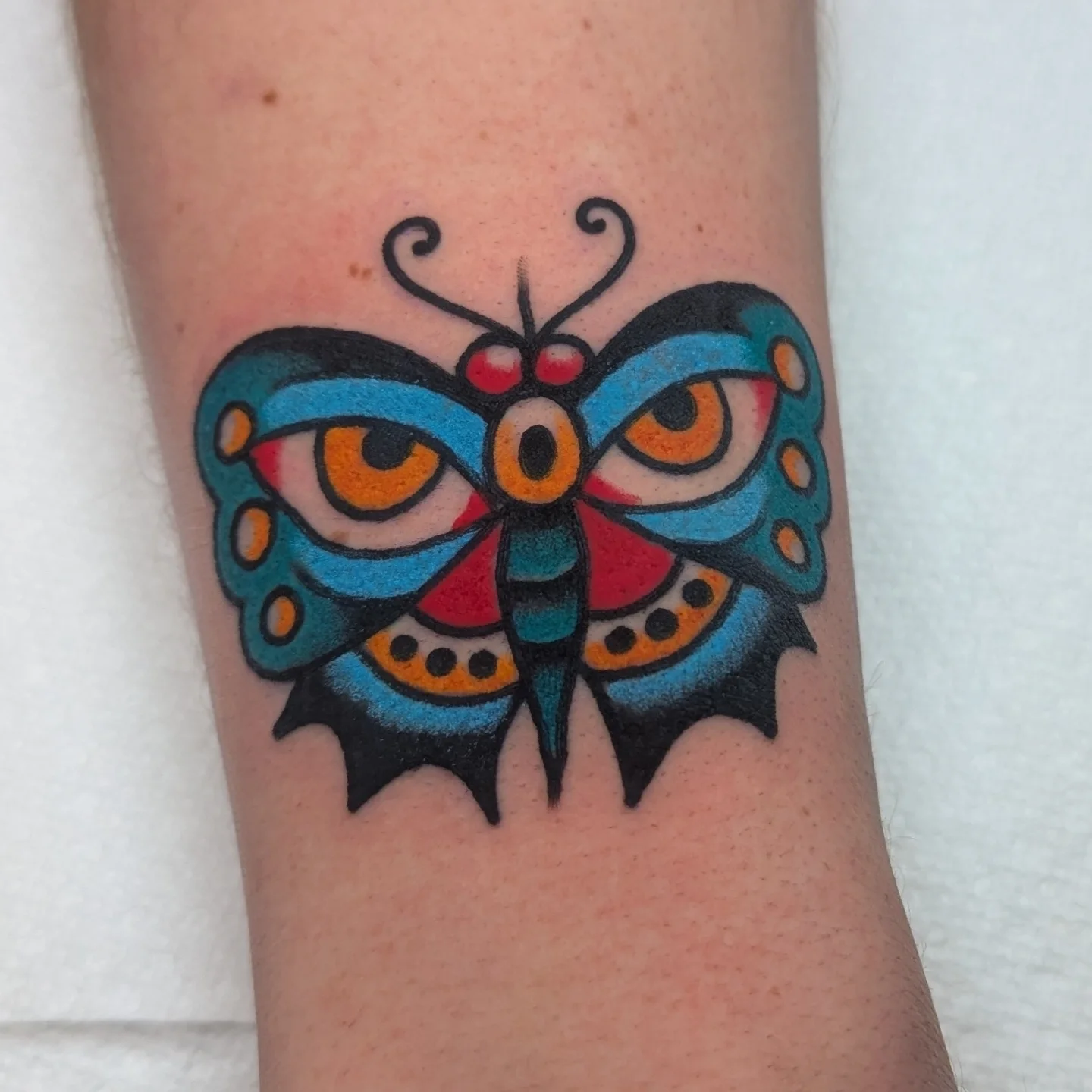 Butterfly new school tattoo on the forearm by Zack Mueller