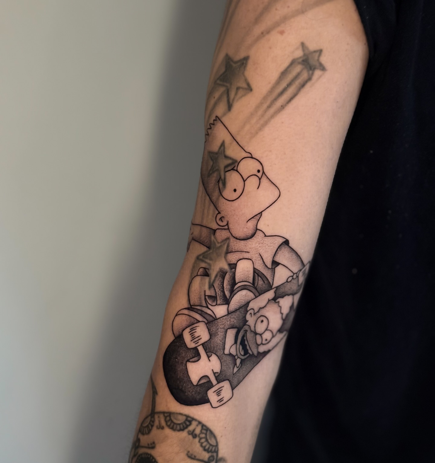 Simpsons characters black and grey tattoo on the forearm by Miami Tattoo Artist, Miami, Florida