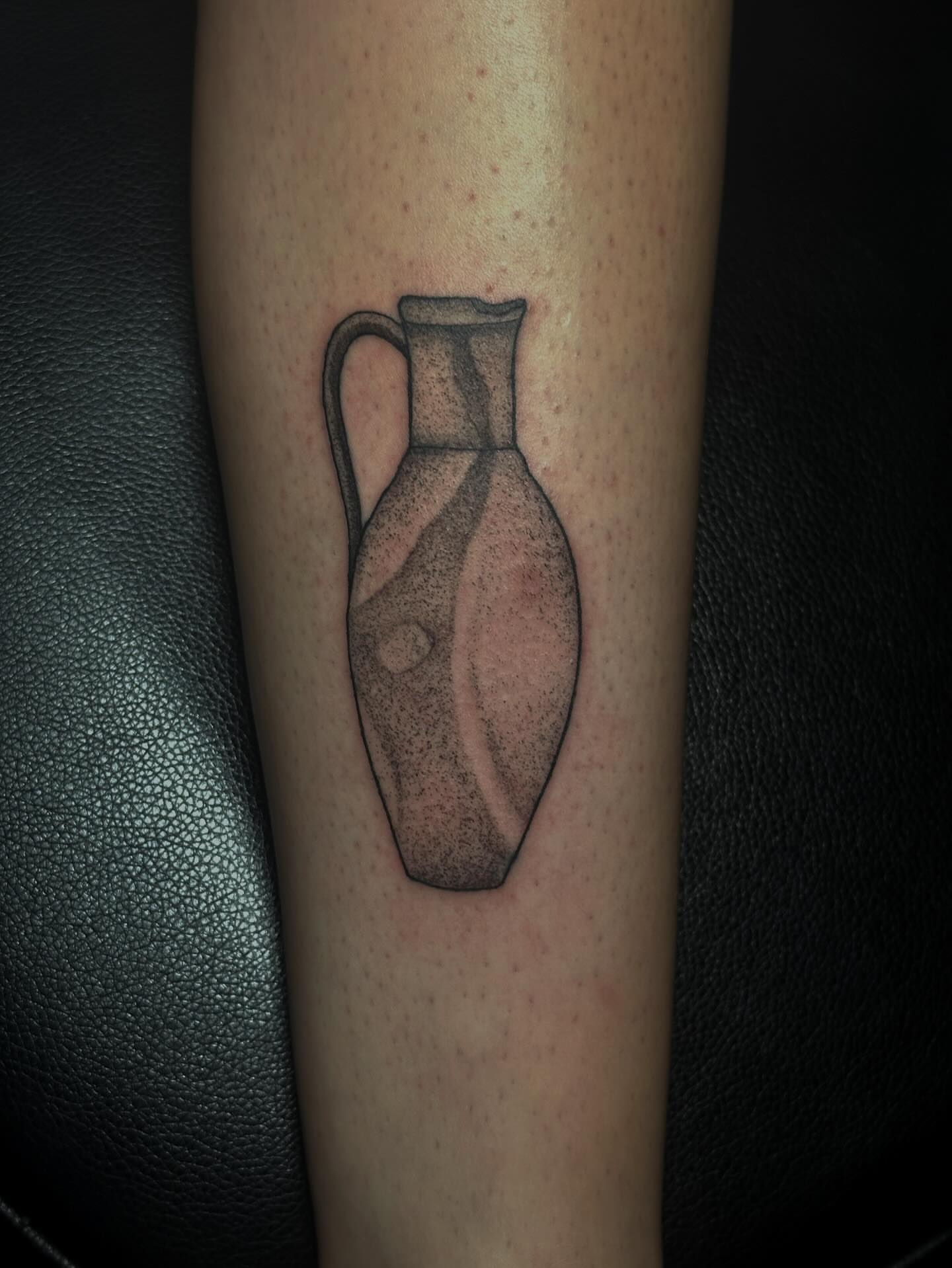 Jug black and grey tattoo on the forearm by Elizabeth Tabler