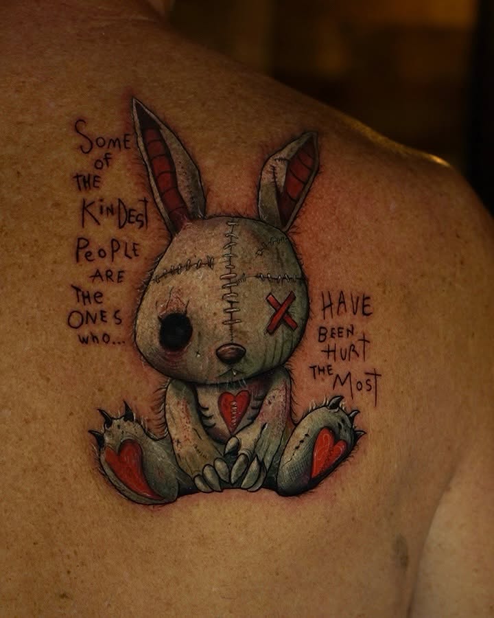 Stuffed rabbit dark realism tattoo on the shoulder by Davier Del Castillo