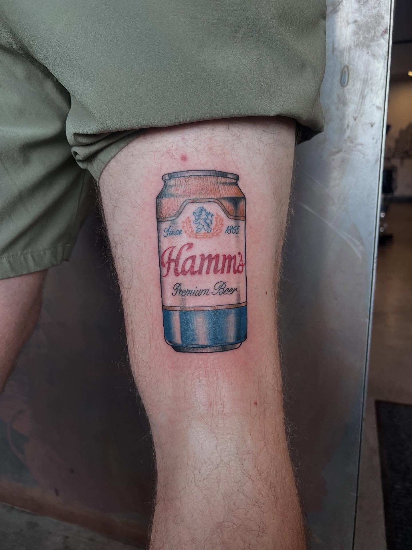 Hamm's beer can realism tattoo on the thigh by Siërra Nicole, Minneapolis, Minnesota