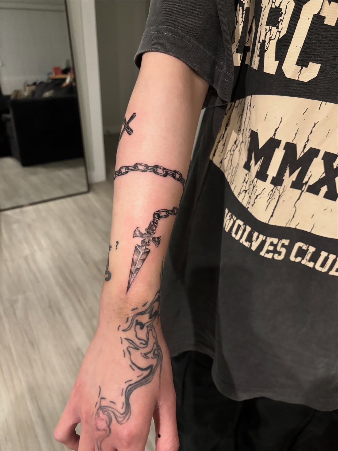 Sword and chain black and grey tattoo on the forearm by @miffythereaper