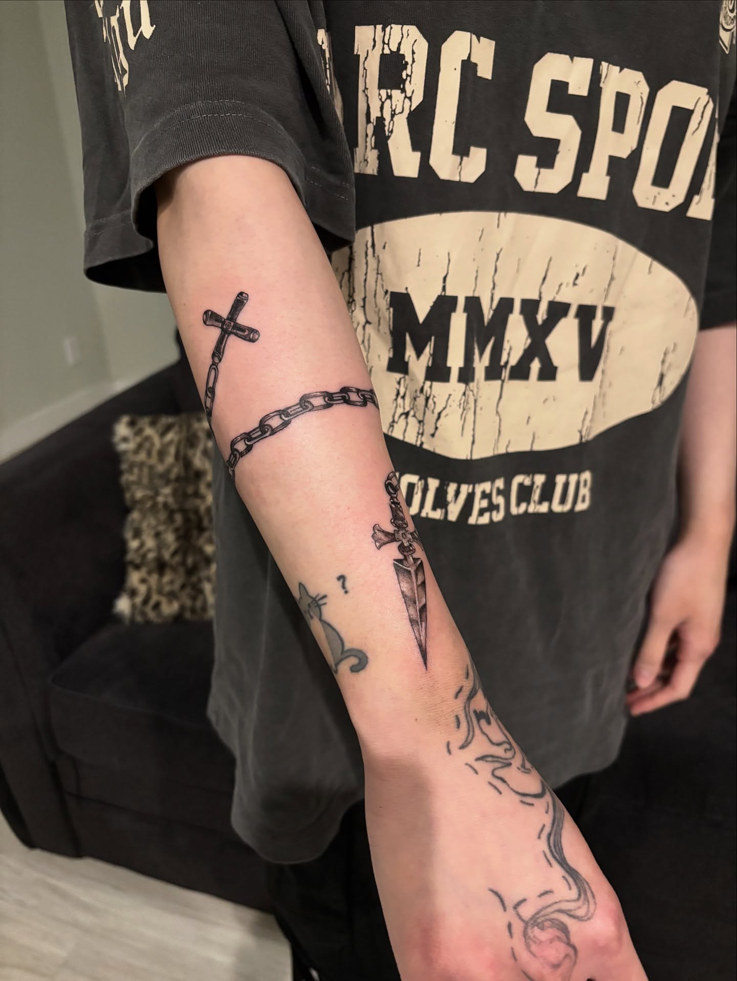 Cross and chain black and grey tattoo on the forearm by @miffythereaper
