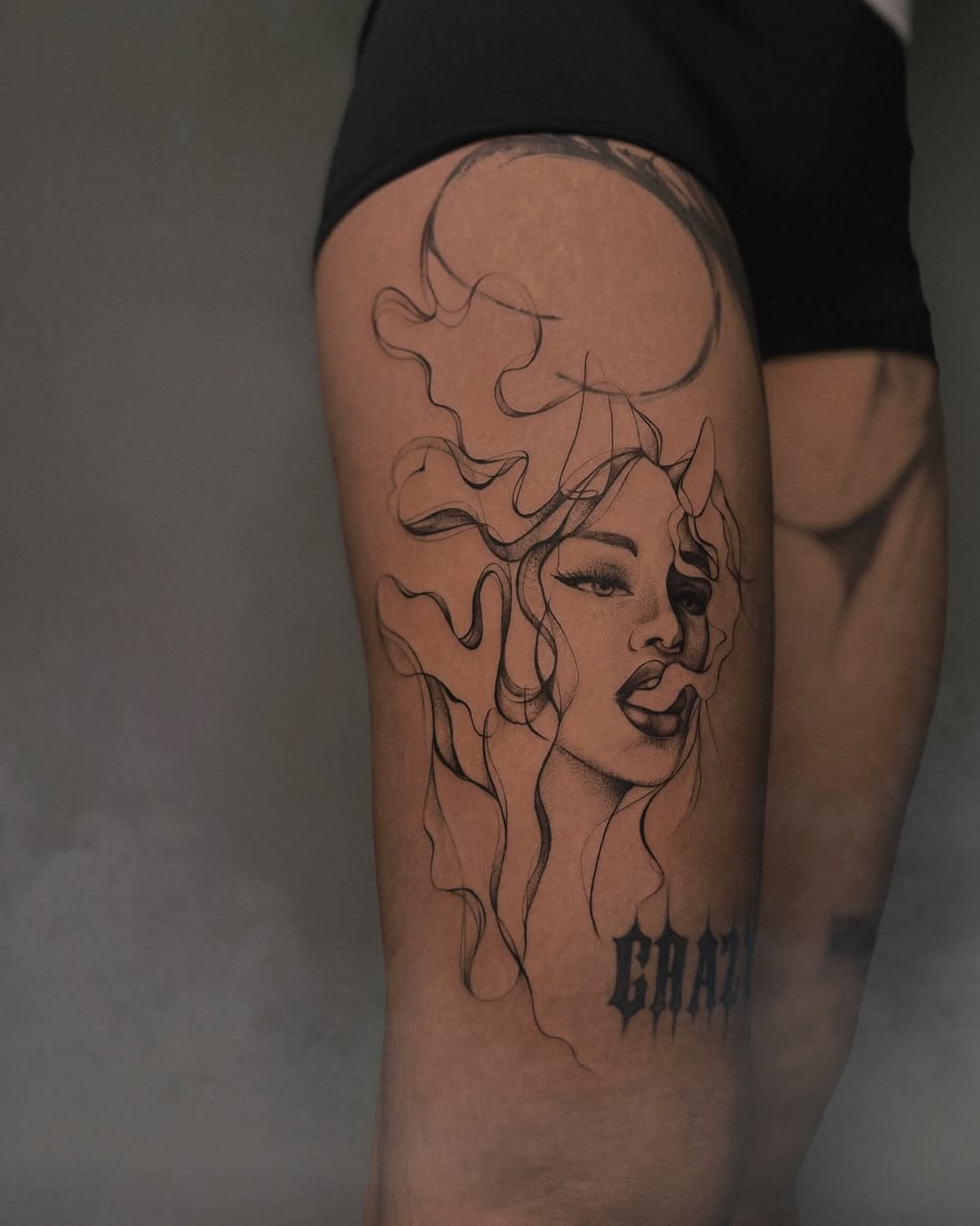 Smoking woman realism tattoo on the thigh by Nina Fedorchenko