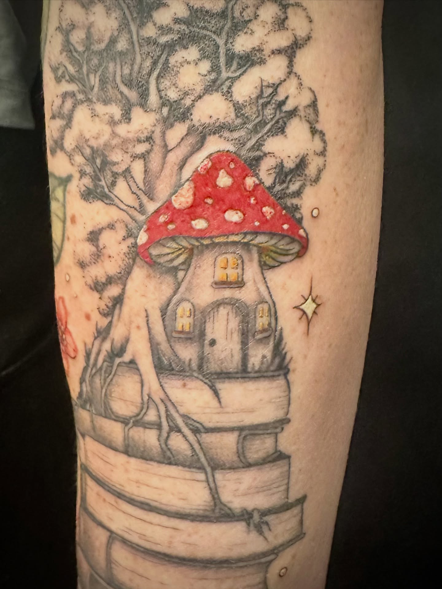 Mushroom house dotwork tattoo on the forearm by Maddie Morrill