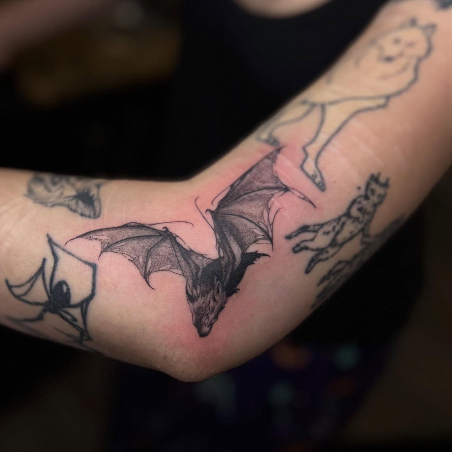 Bat black and grey tattoo on the forearm by Gladys L.