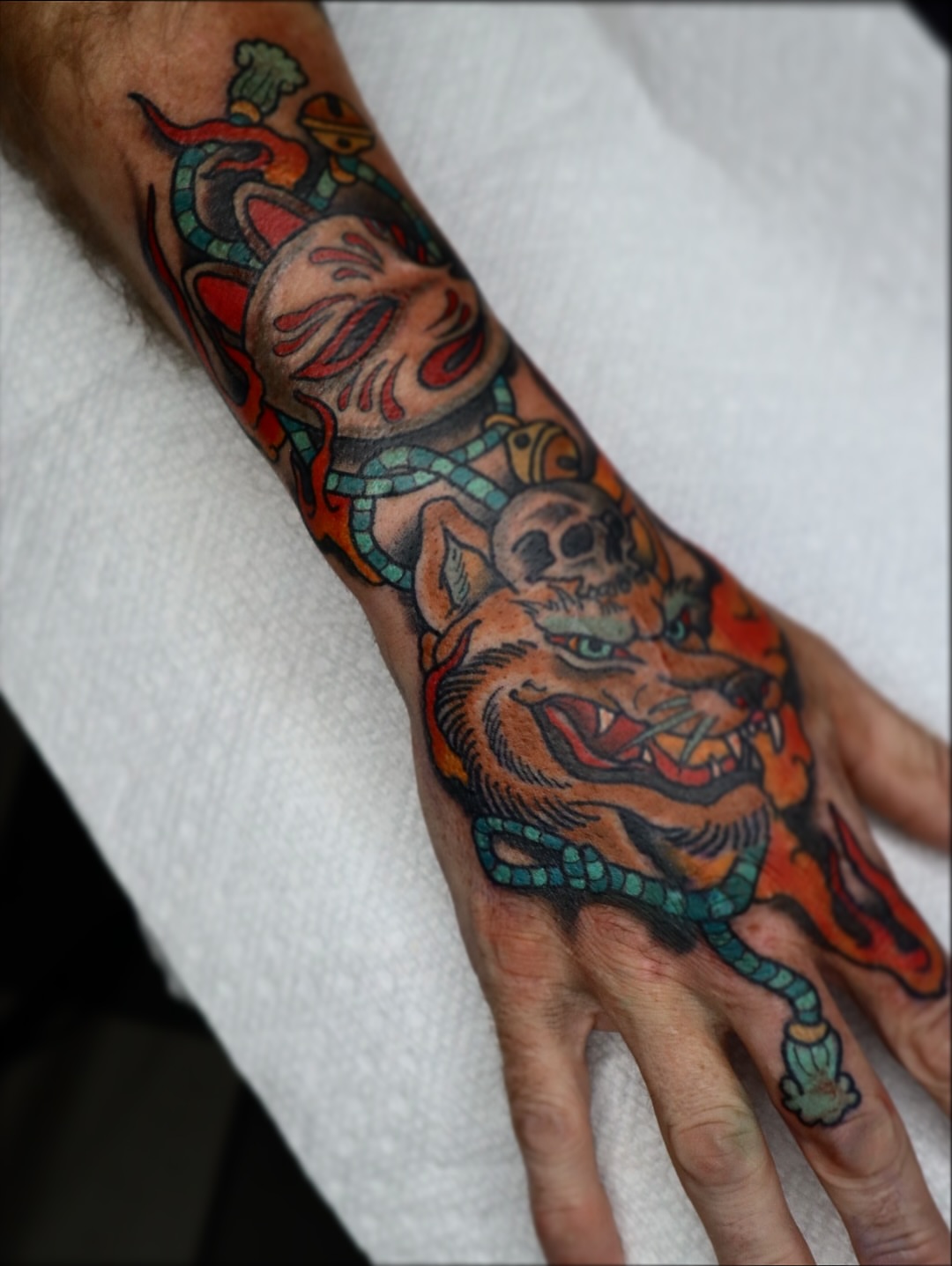 Tiger and skull American traditional tattoo on the hand by Stephen Shaw