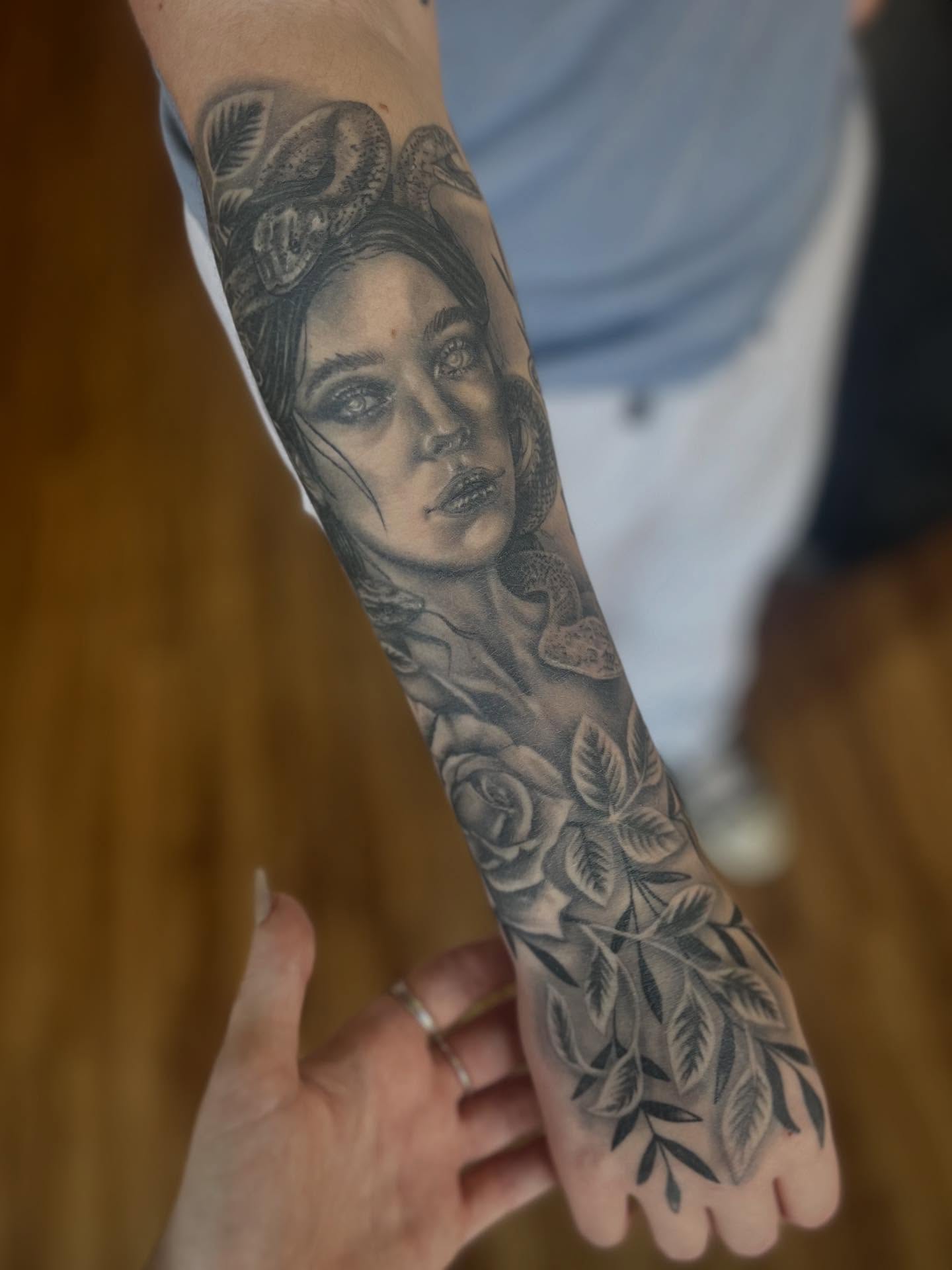 Woman with roses realism tattoo on the forearm by Taylor Santavicca