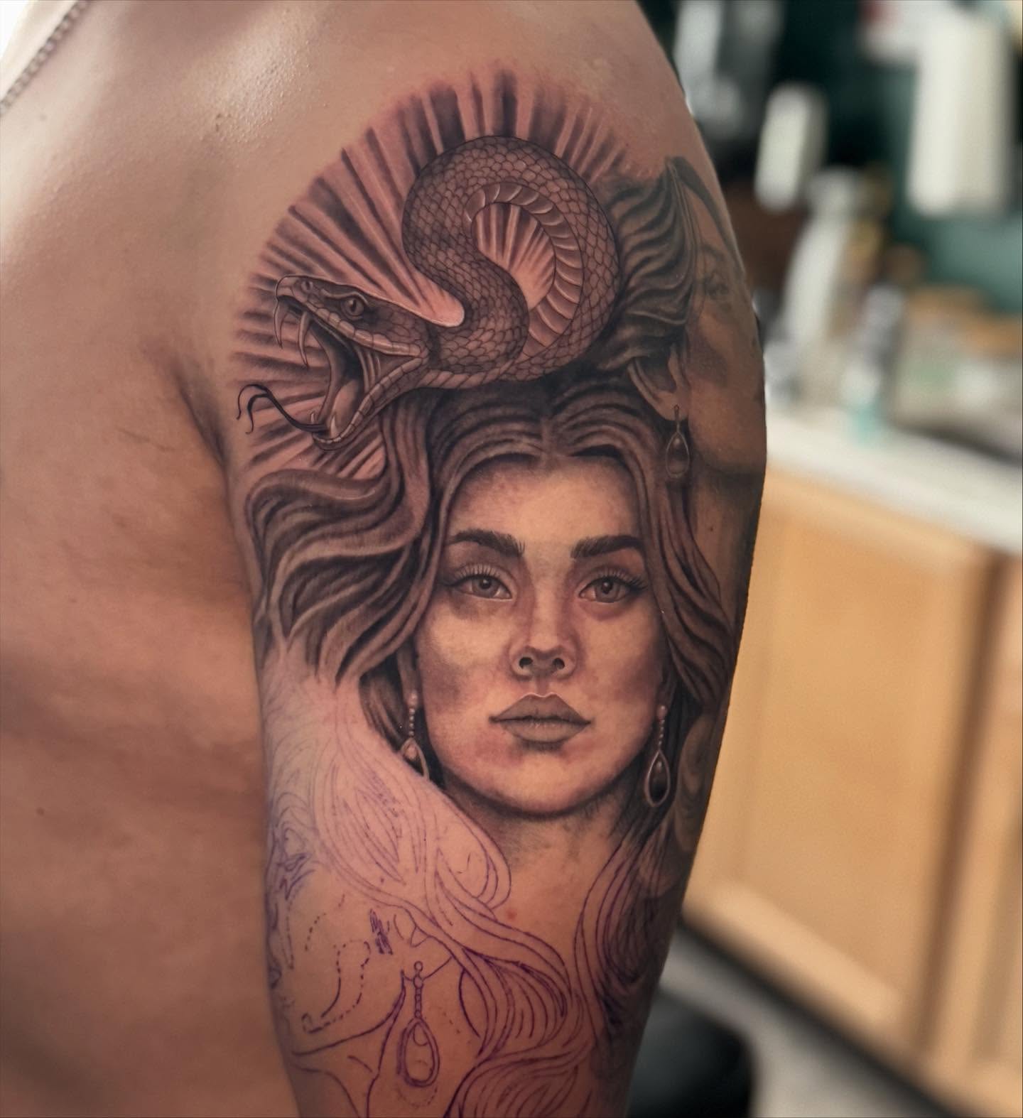 Woman with snake realism tattoo on the forearm by Leslea Hipp