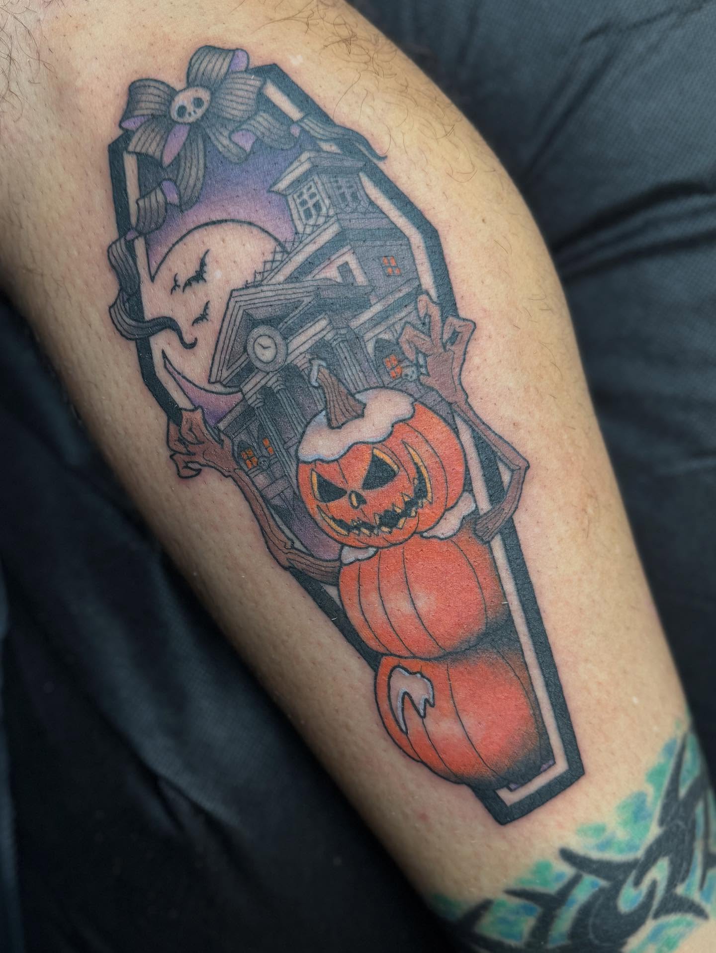 Pumpkin and haunted house American traditional tattoo on the forearm by Chase Martines
