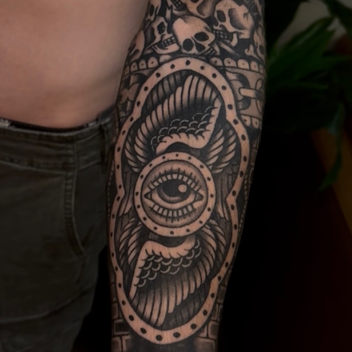 Eye with mechanical wings geometric tattoo on the forearm by Cory Allen