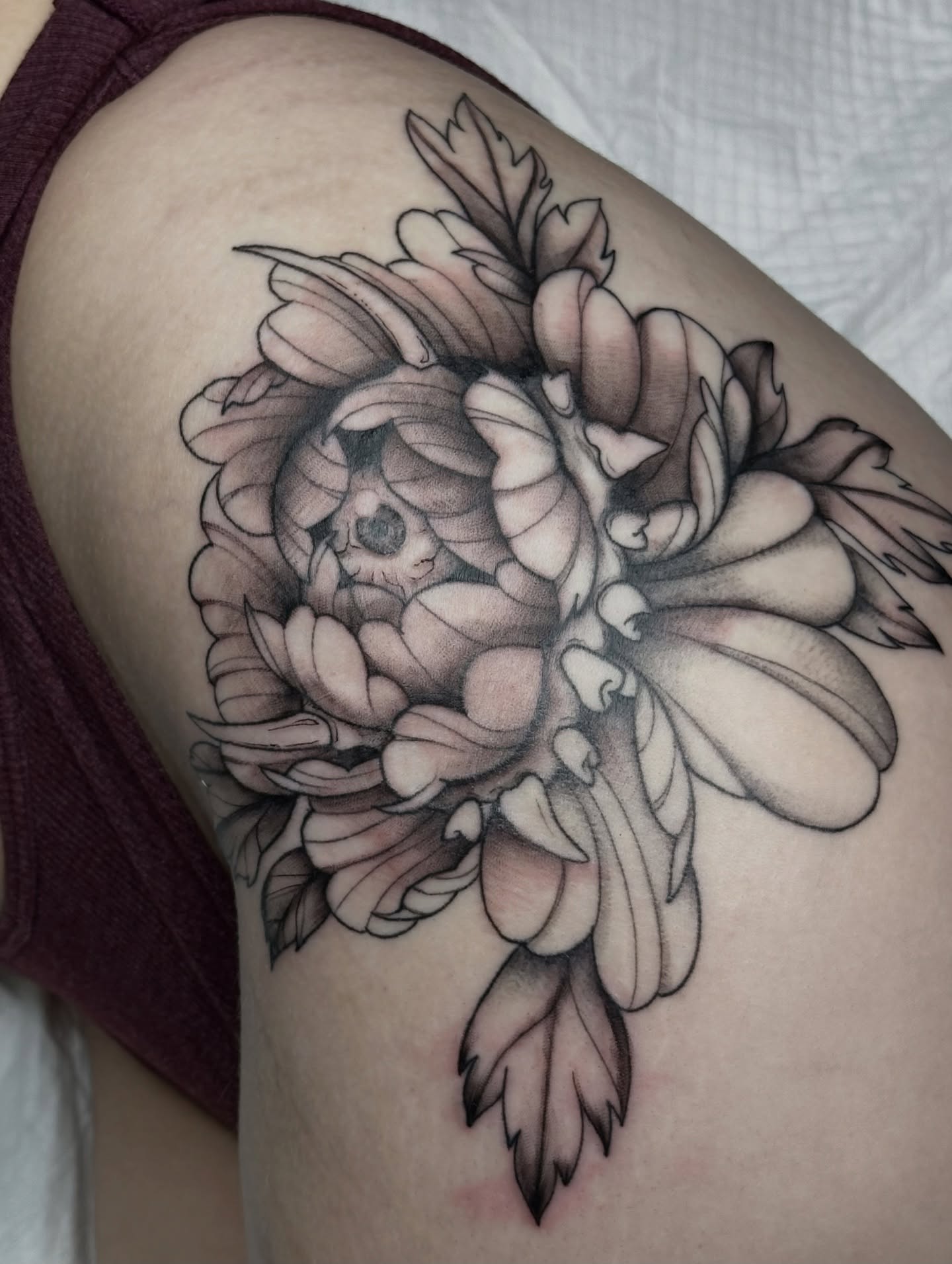 Peony and skull realism tattoo on the shoulder by father