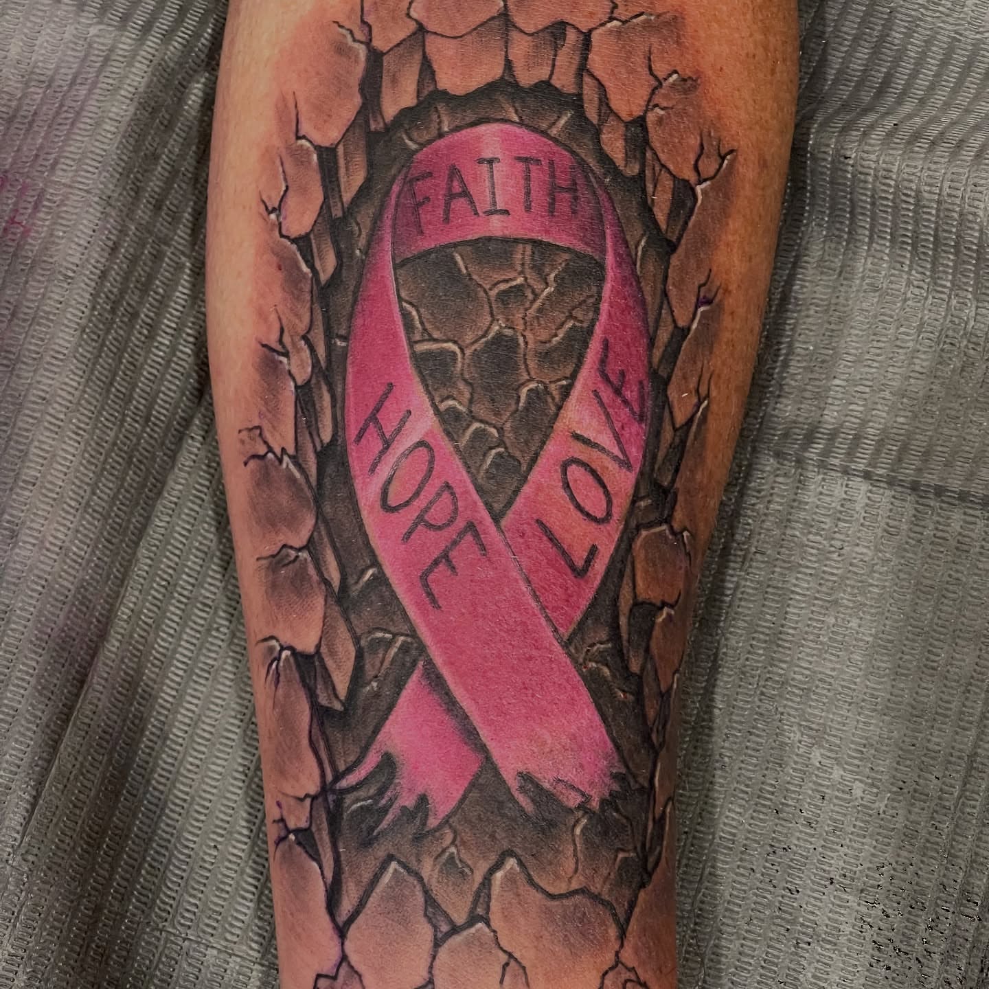 Breast cancer awareness ribbon realism tattoo on the forearm by Dale Callahan, Olympia, Washington