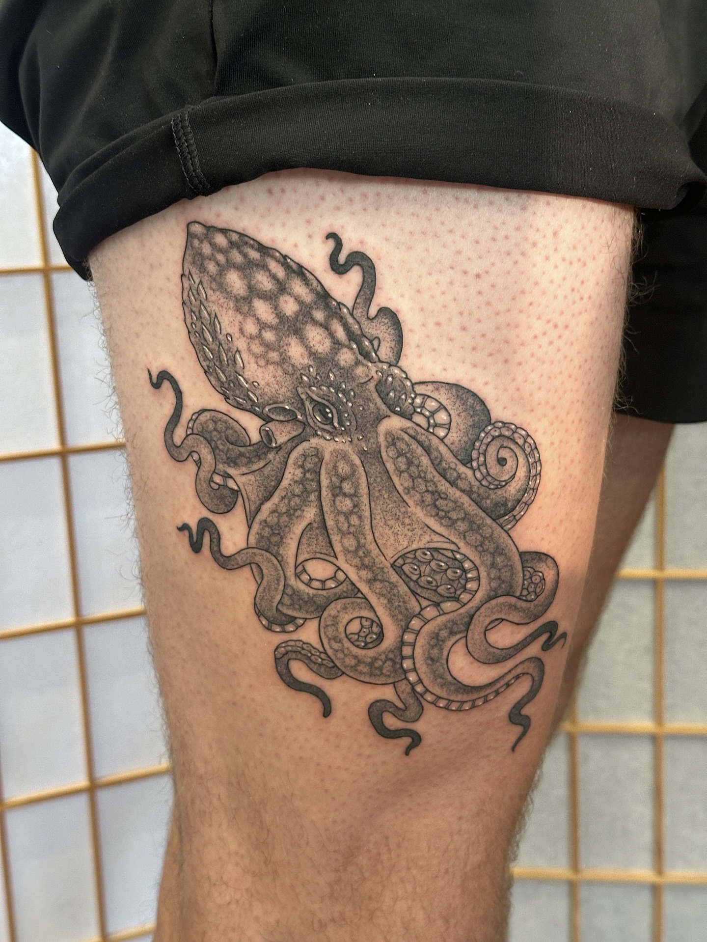 Octopus black and grey tattoo on the thigh by Tattooing by Patty Valentine