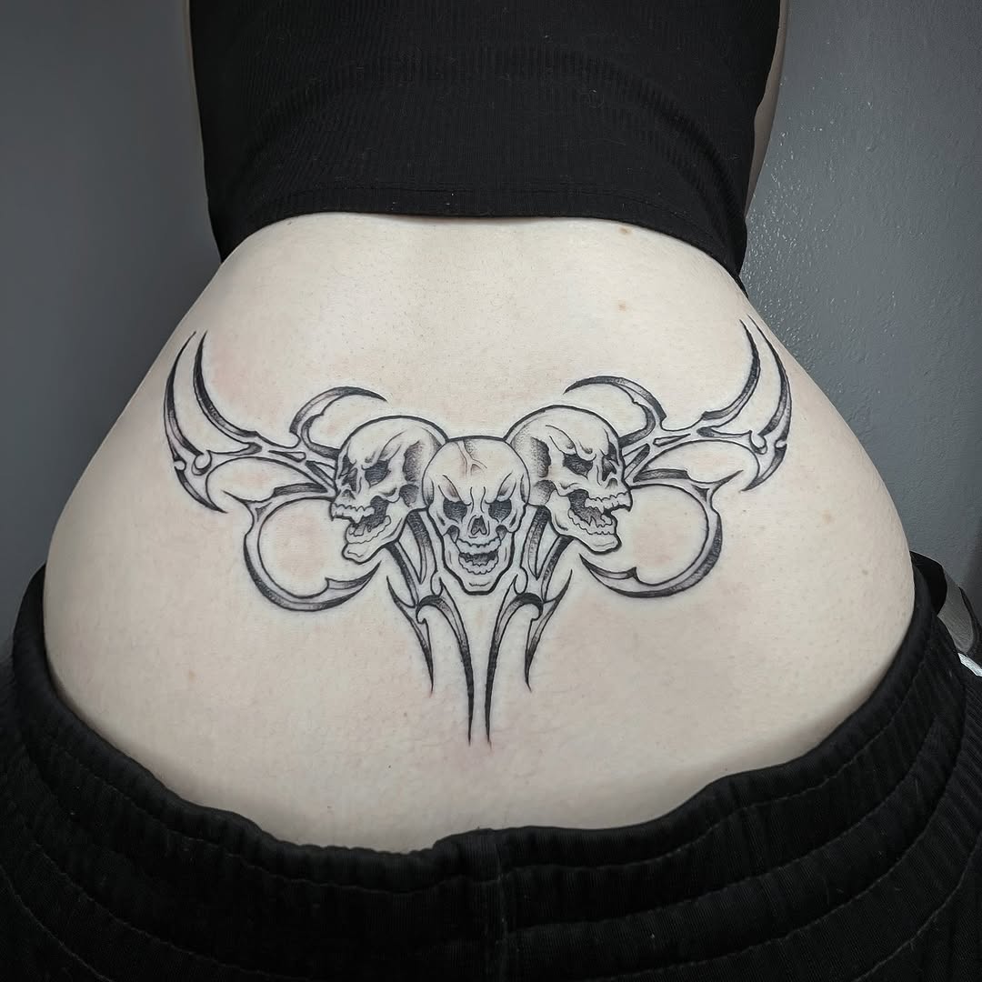 Three skulls with tribal elements cyber sigilism tattoo on the thigh by Sara Atamian, San Diego, California