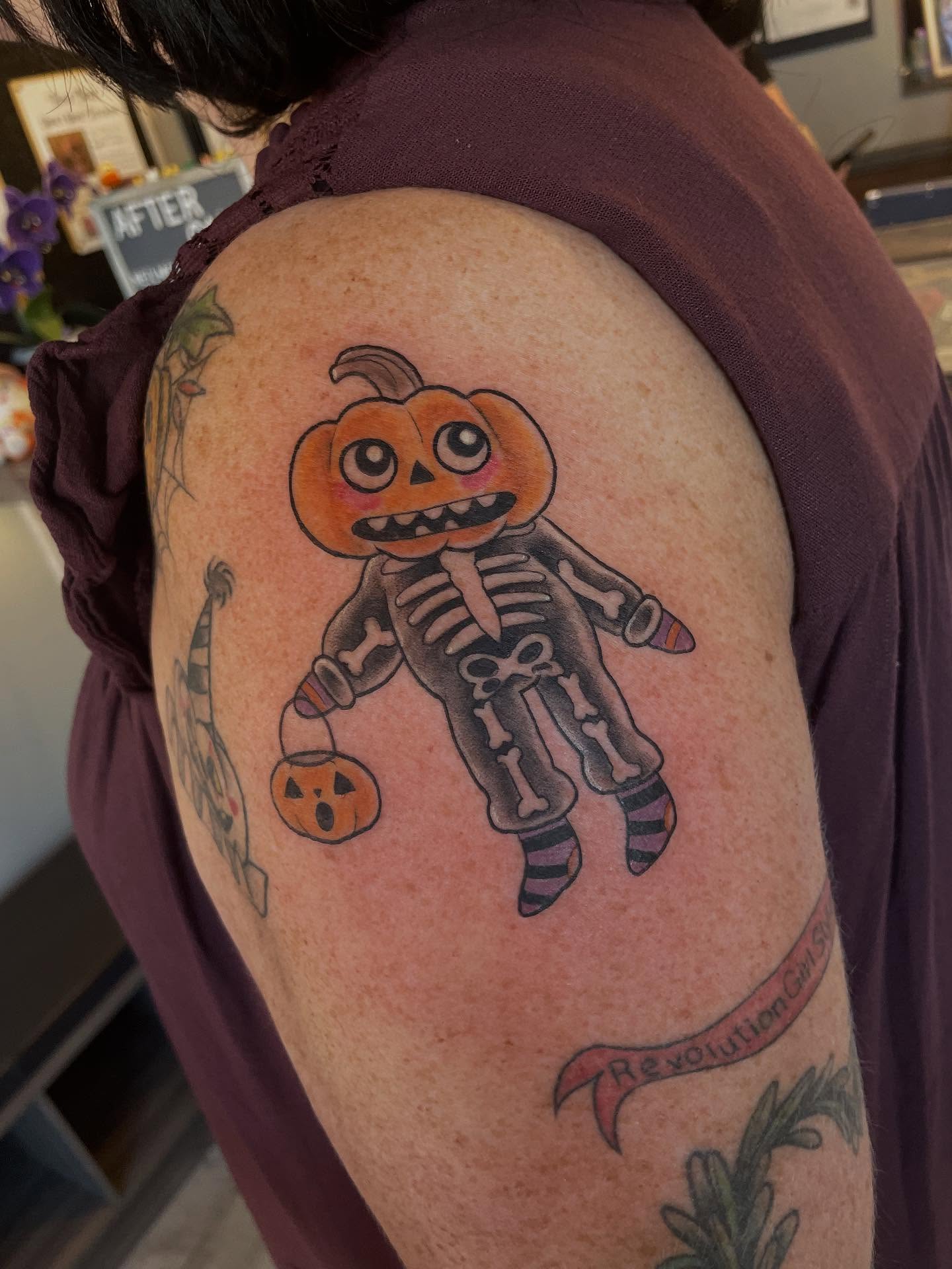 Pumpkin skeleton new school tattoo on the shoulder by Stevie Timmreck, Utica, Michigan