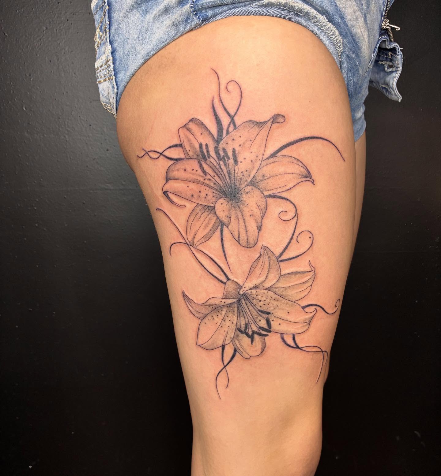 Lily flowers black and grey tattoo on the thigh by Kat π
