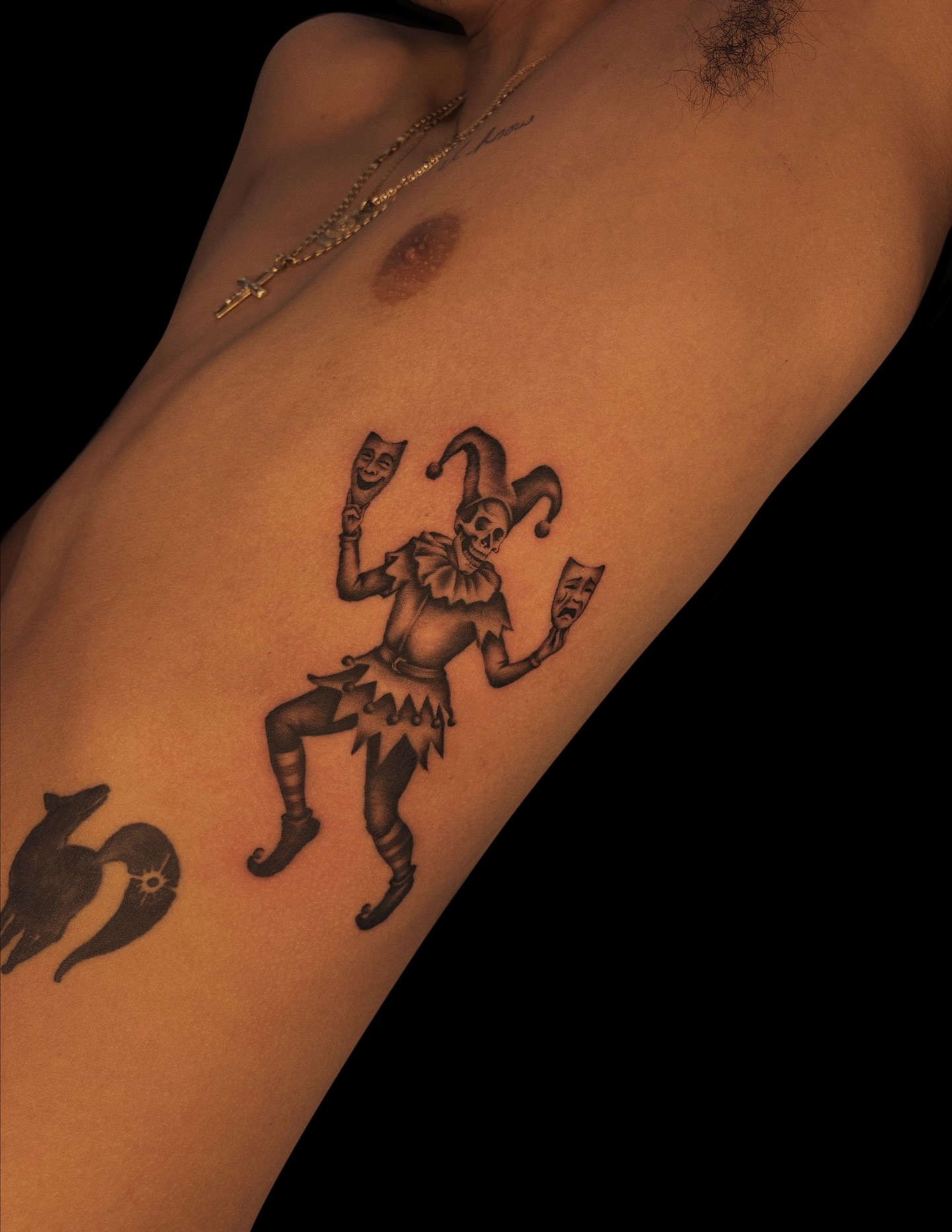 Jester black and grey tattoo on the ribs by Jason