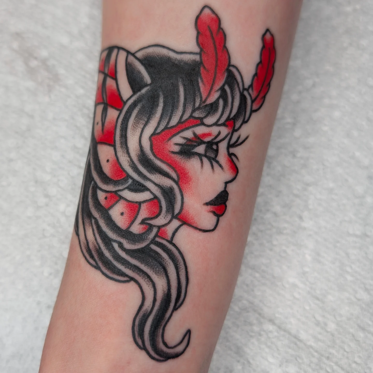 Woman's profile American traditional tattoo on the forearm by Aiden Krone, San Diego, California