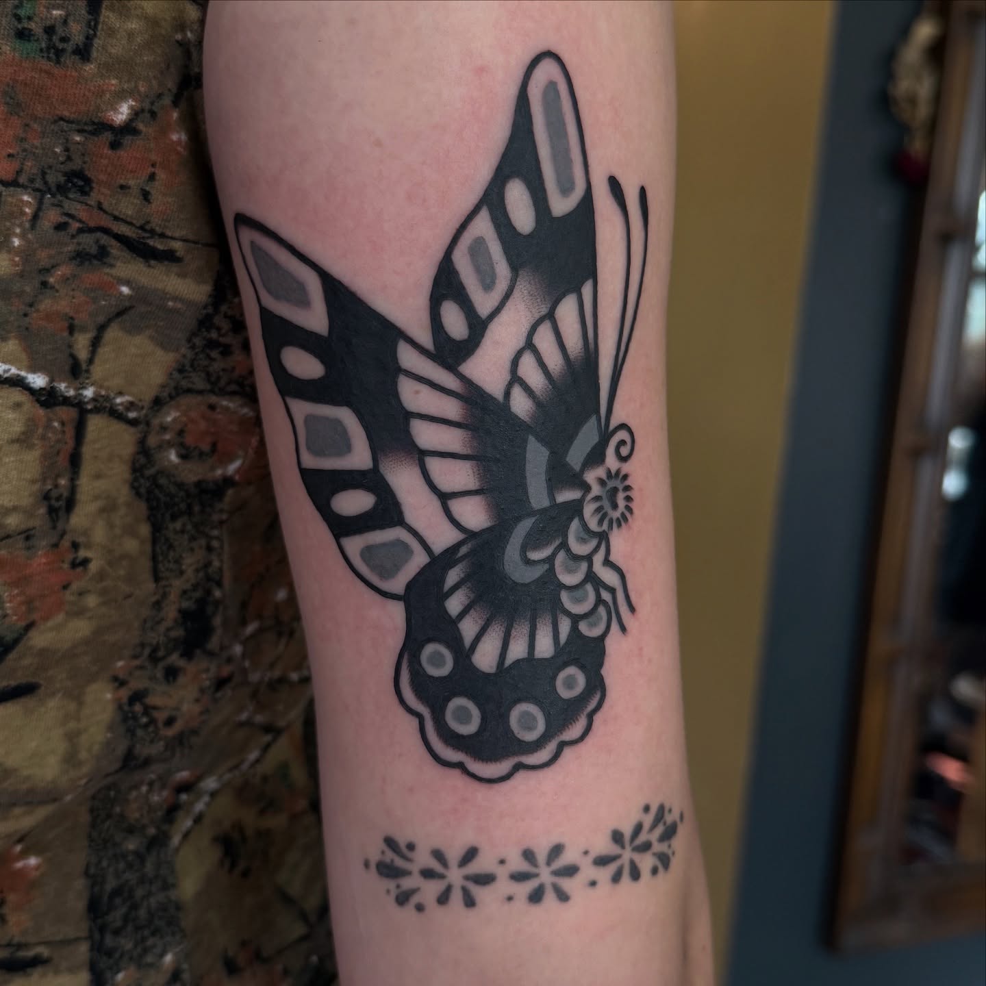 Butterfly black and grey tattoo on the forearm by Erin Chambers
