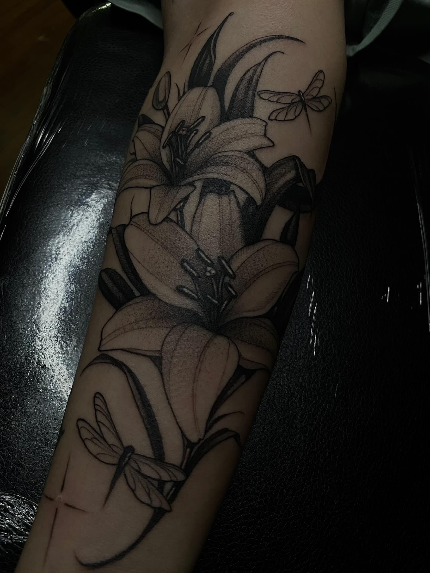Lilies and dragonflies realism tattoo on the forearm by 𝔗𝔞𝔶𝔩𝔬𝔯 𝔈𝔩𝔦𝔷𝔞𝔟𝔢𝔱𝔥, Tulsa, Oklahoma