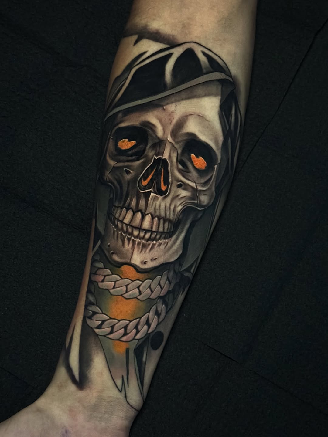 Skull with chain realism tattoo on the forearm by Jaxx Kesler