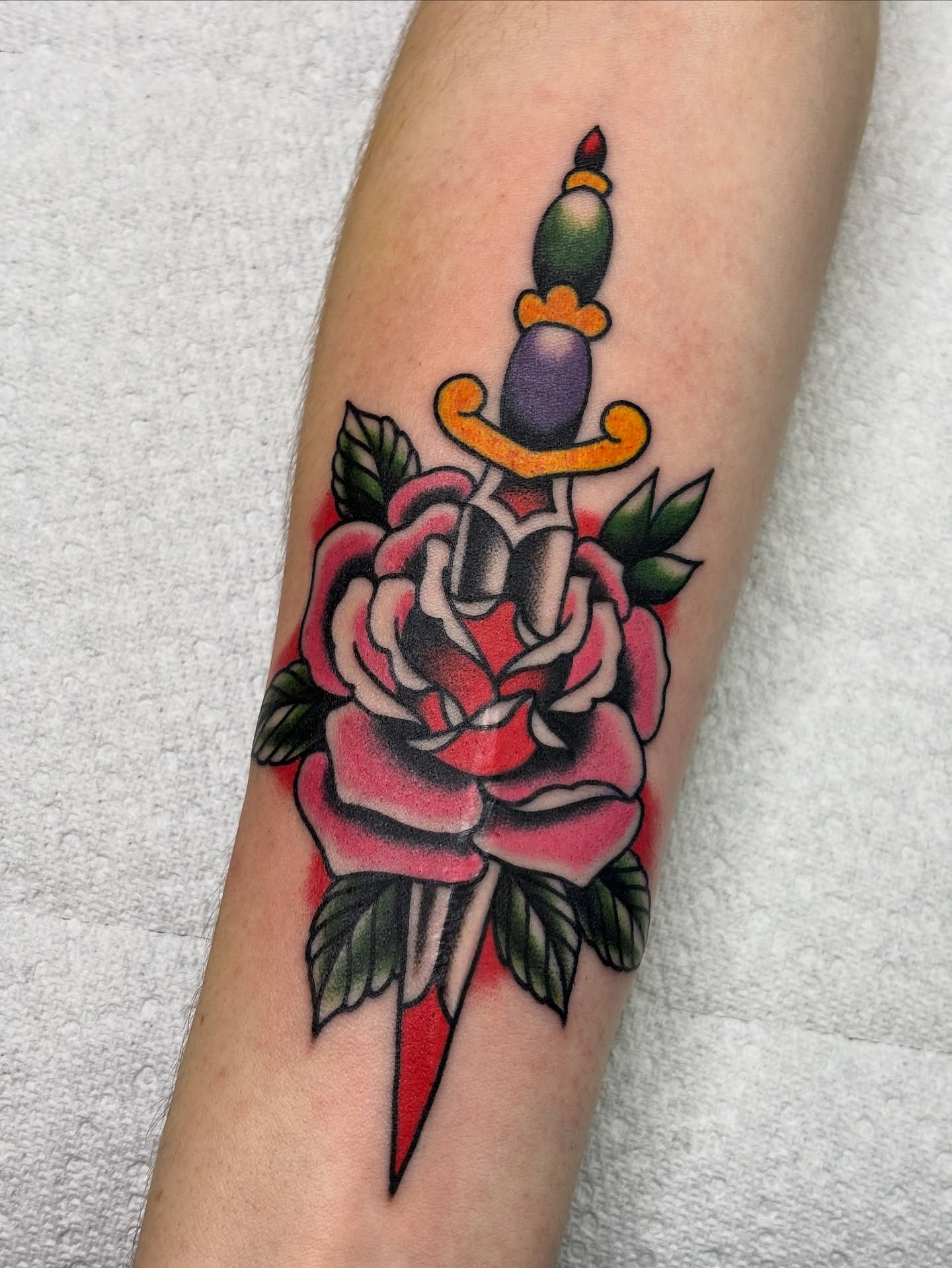 Rose and dagger American traditional tattoo on the forearm by Mike DiCicco