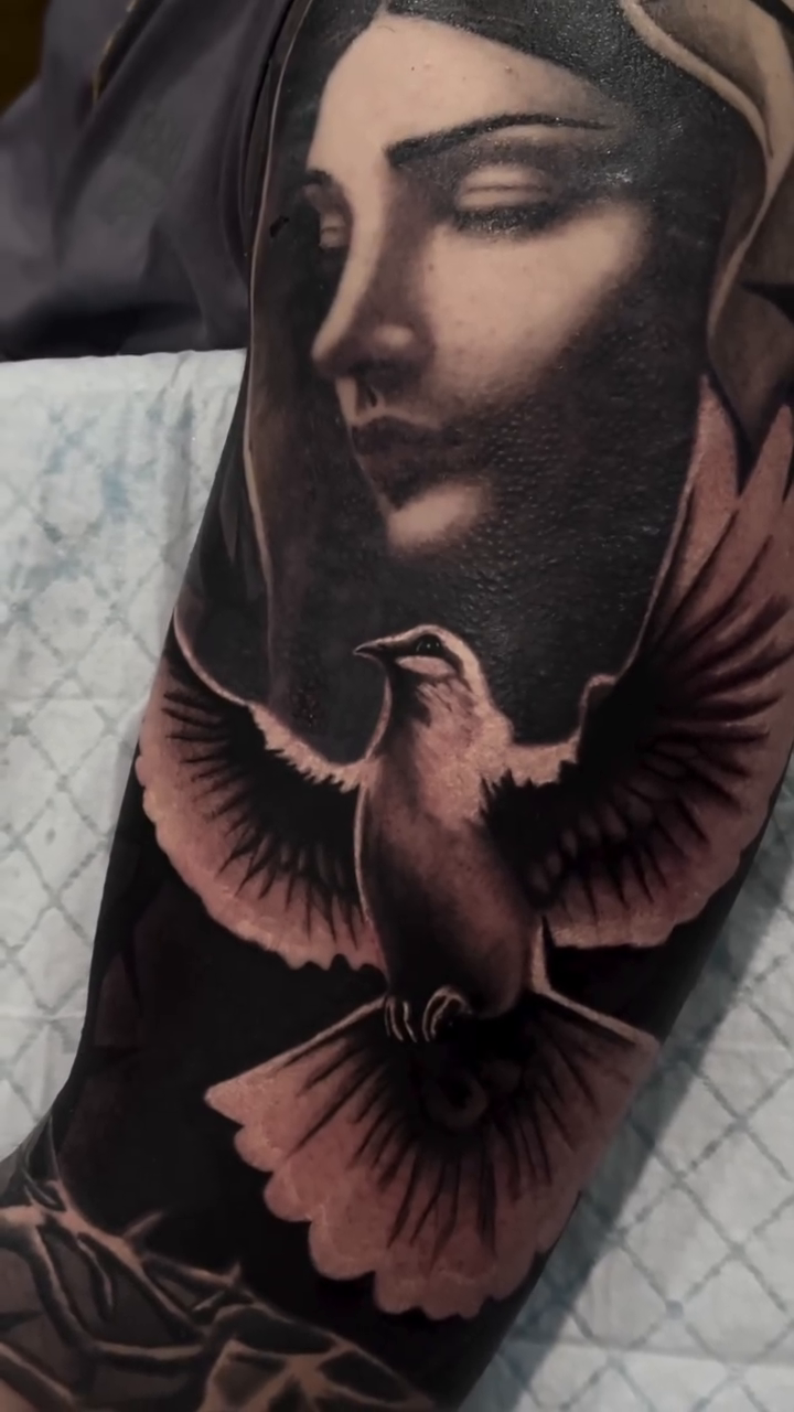 Woman and dove realism tattoo by caleb coley