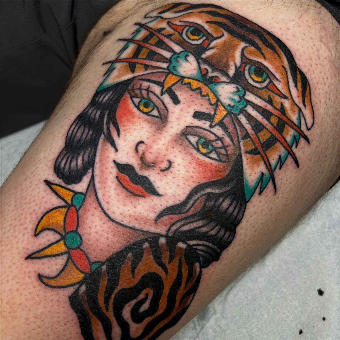 Woman with tiger American traditional tattoo on the thigh by Erin Einhorn