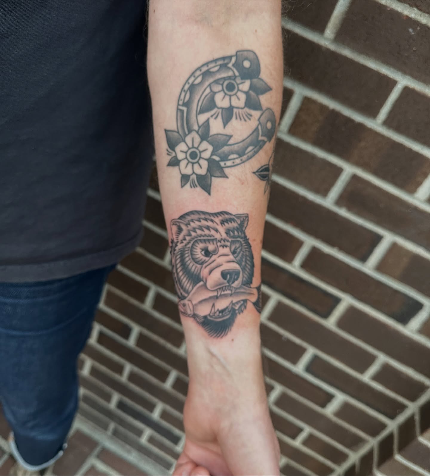 Bear and horseshoe black and grey tattoo on the forearm by Hail Chaney, Somerville, Massachusetts