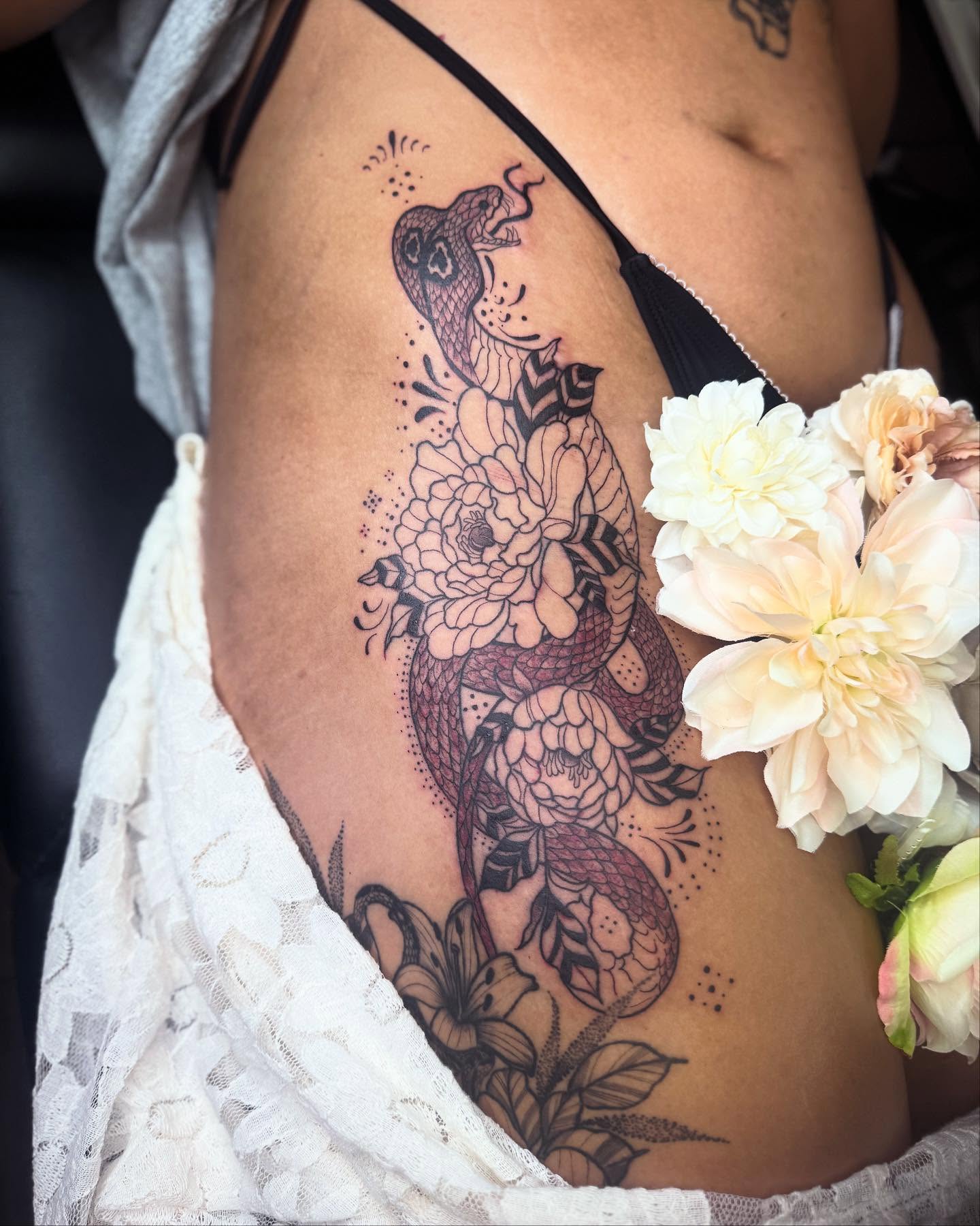 Snake and peony dotwork tattoo on the thigh by Skitty Tattoo Artist