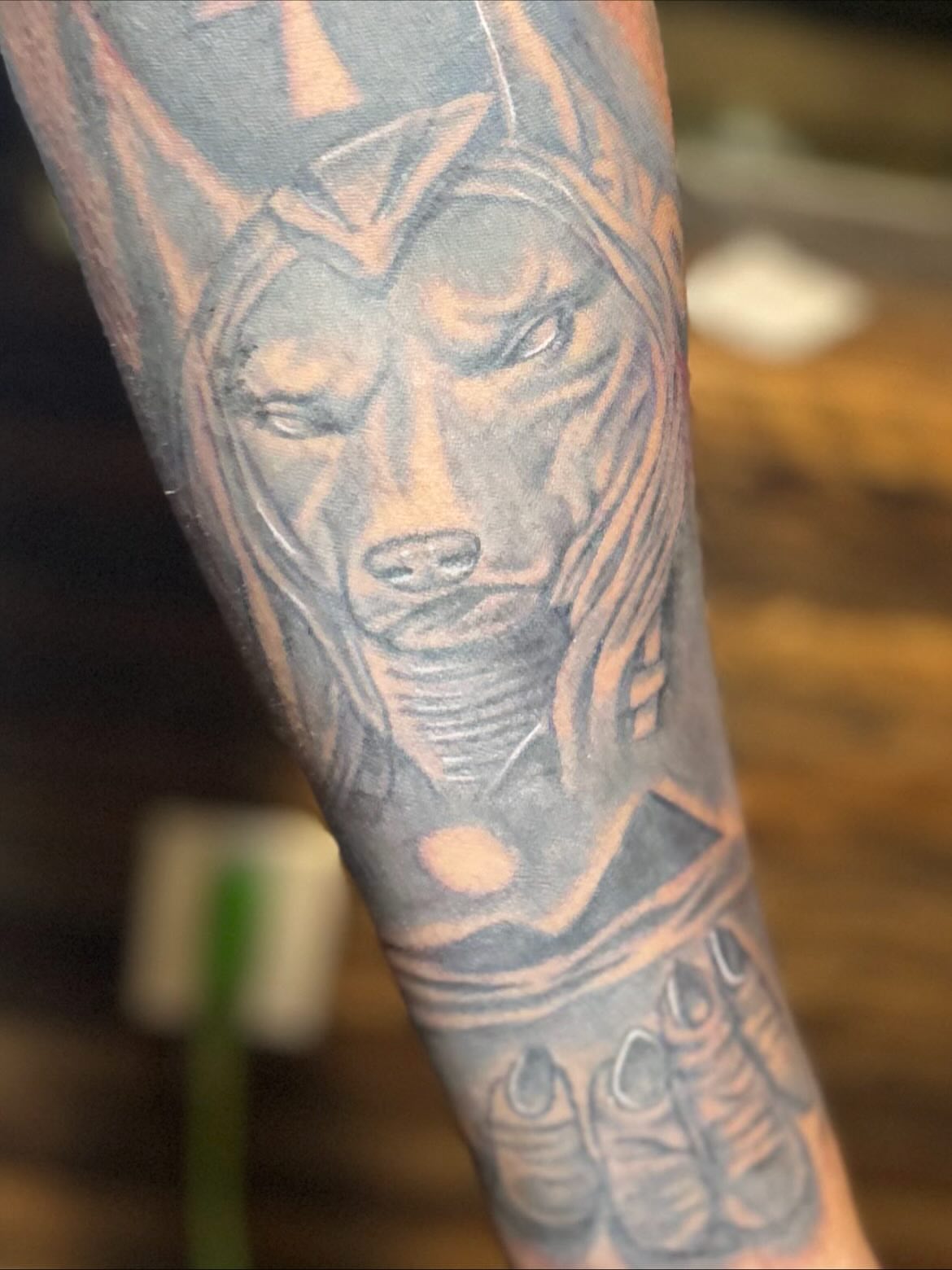Ancient god black and grey tattoo on the forearm by DC
