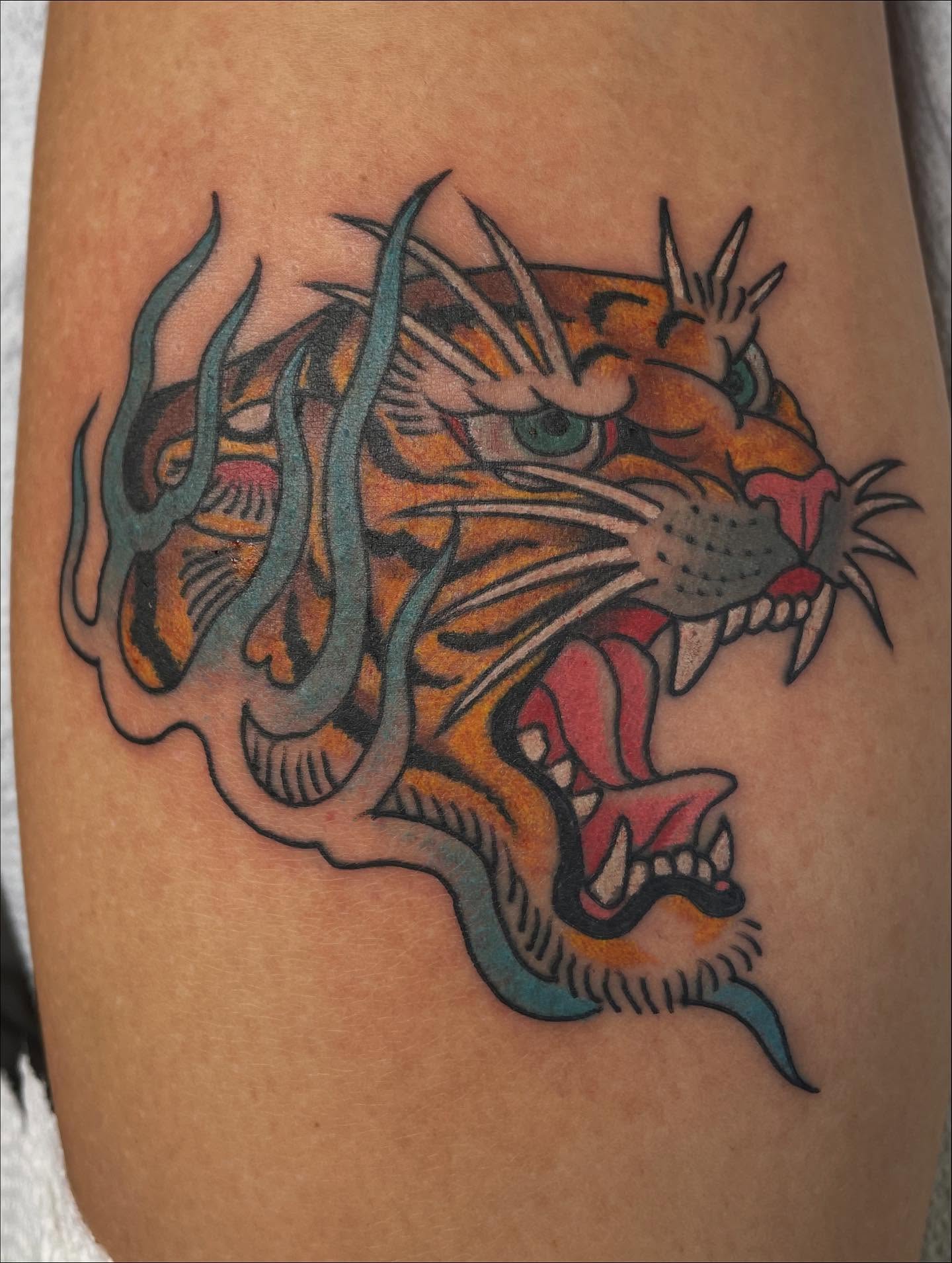 Tiger American traditional tattoo on the thigh by Haley McMahon