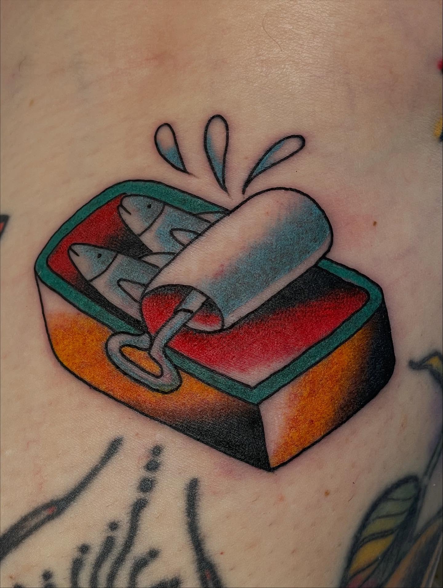 Tuna can American traditional tattoo on the upper arm by Haley McMahon