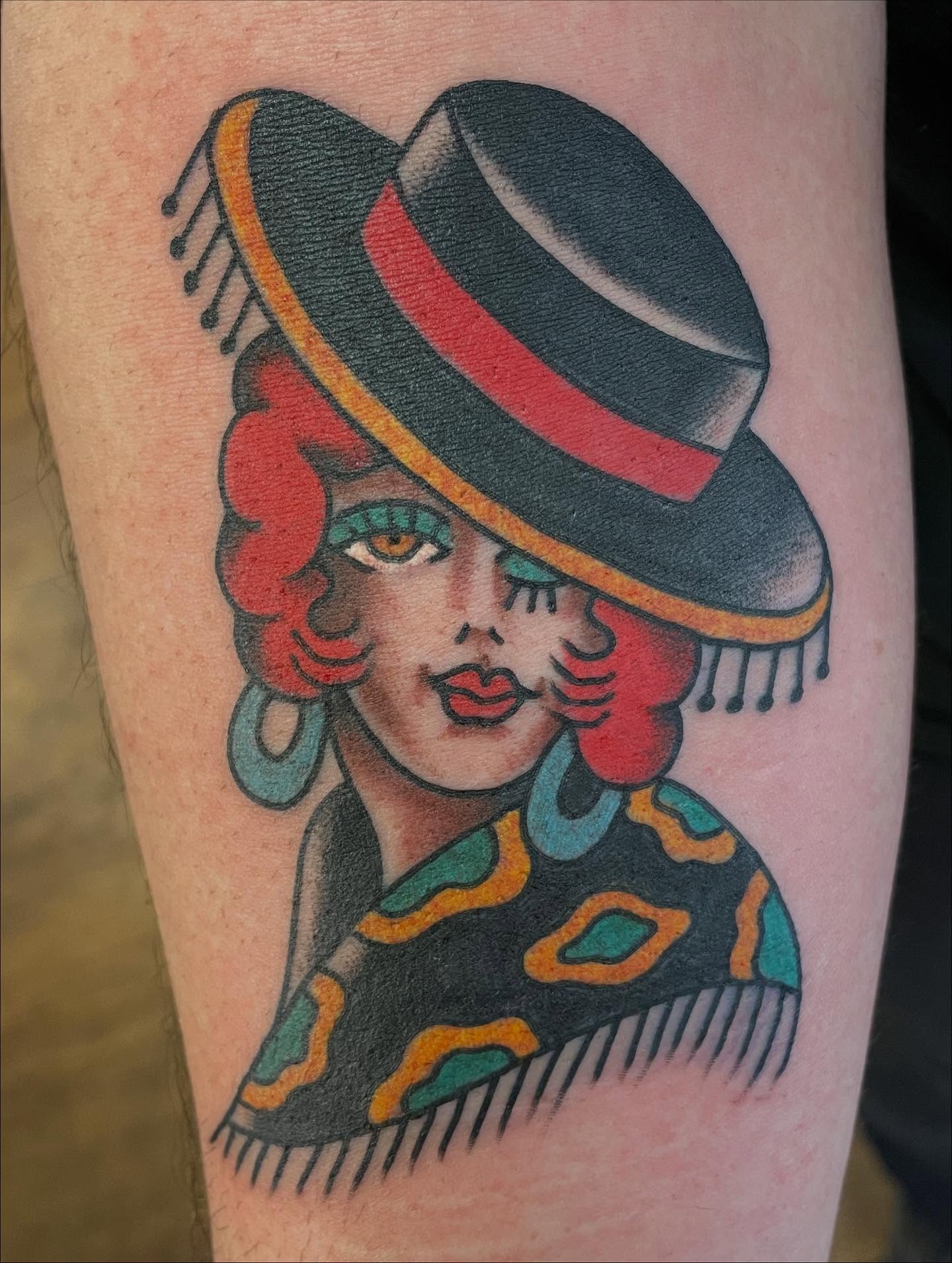 Woman wearing hat American traditional tattoo on the forearm by Haley McMahon
