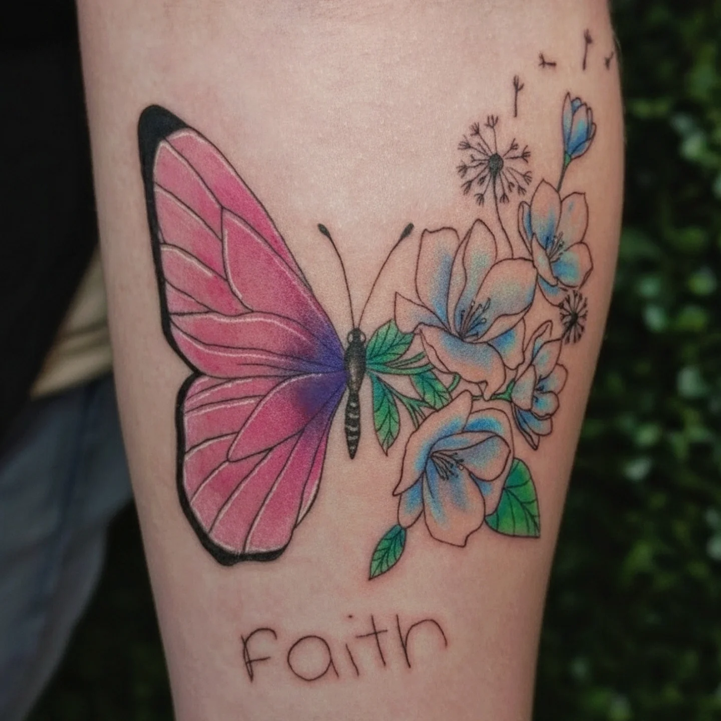 Butterfly and flowers realism tattoo on the forearm by Marlayna Connelly