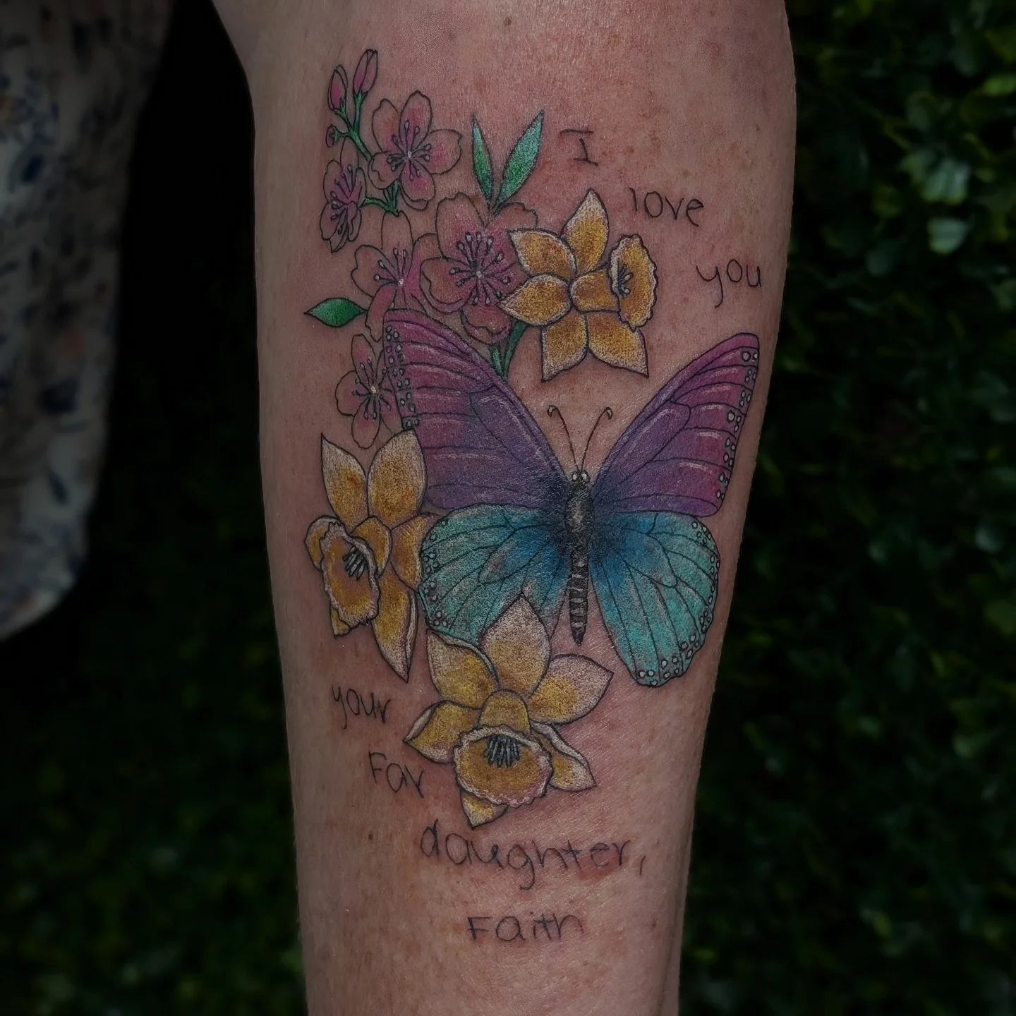 Butterfly and flowers new school tattoo on the forearm by Marlayna Connelly