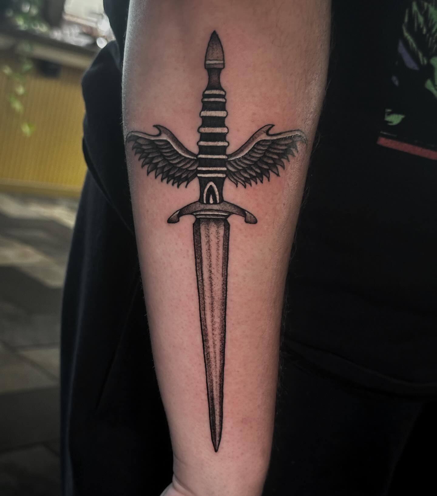 Sword with wings dotwork tattoo on the forearm by Elizabeth Tabler