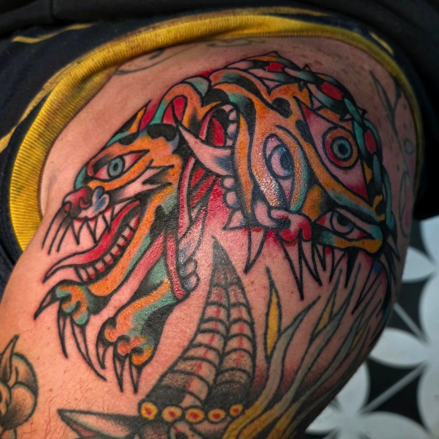 Tiger American traditional tattoo on the shoulder by Mitch Braver