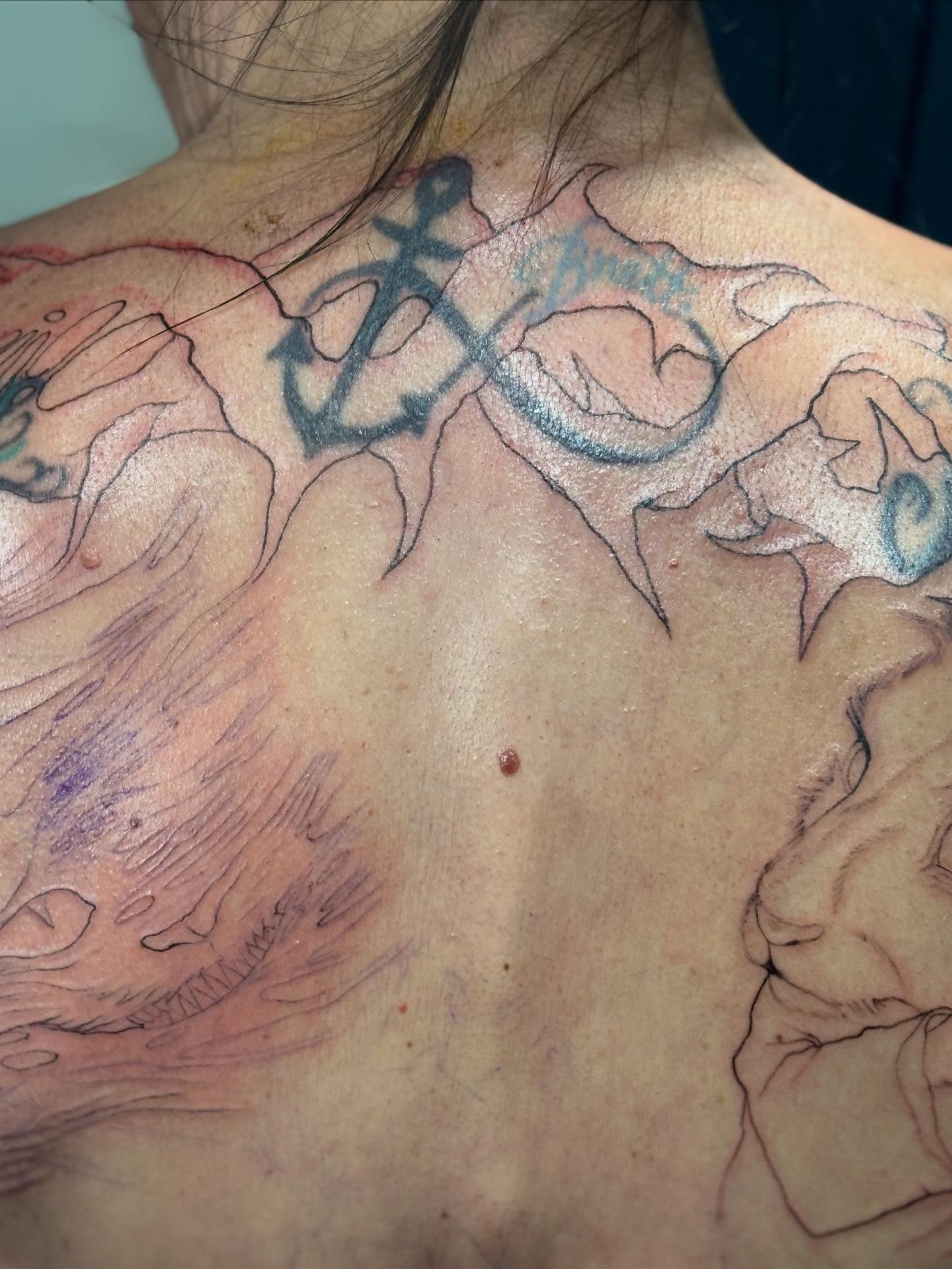 Anchor and waves black and grey tattoo on the back by Slade Nowicki