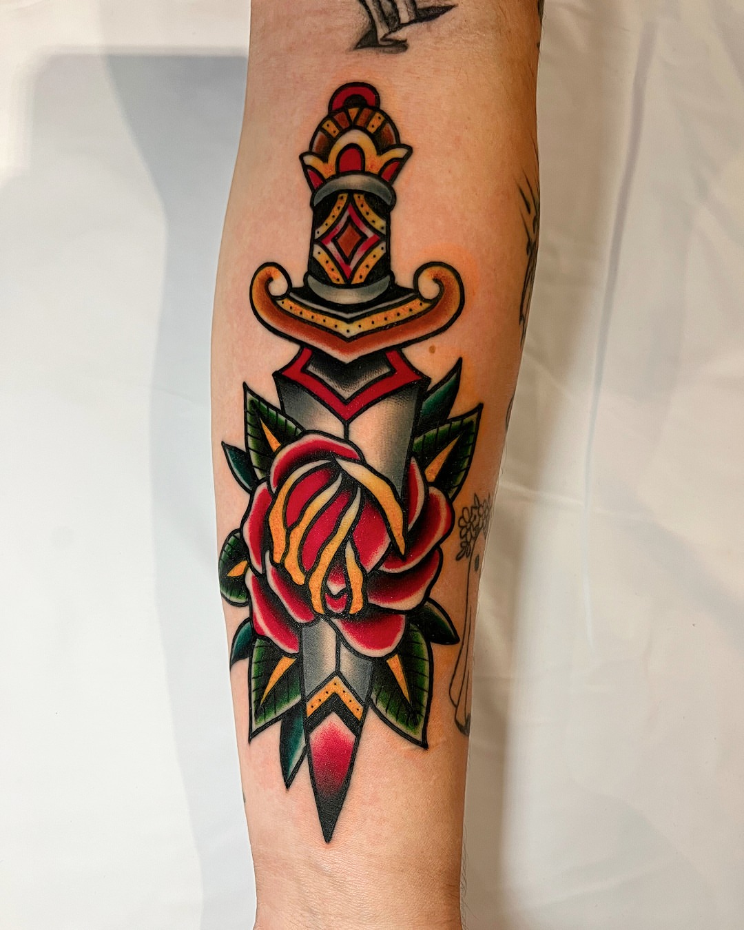 Sword and rose American traditional tattoo on the forearm by Massimiliano pennella